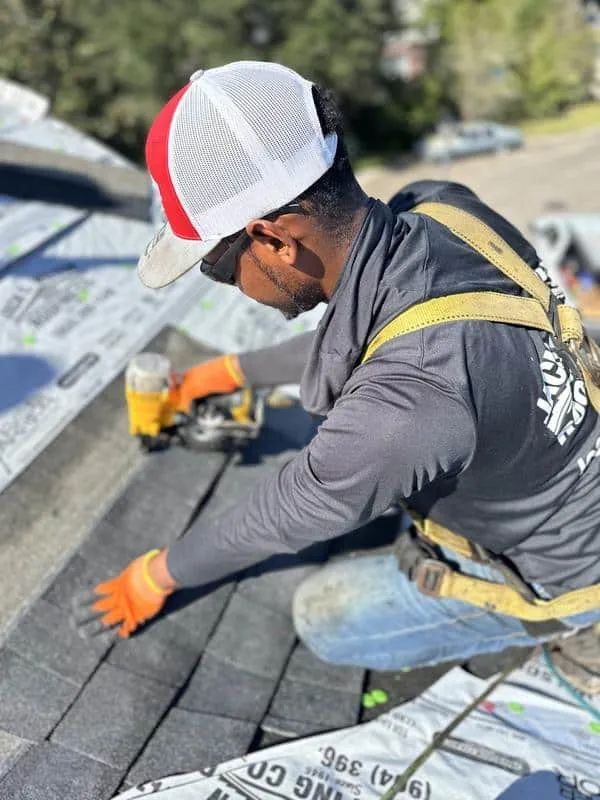 A Jack C. Wilson roofer installing shingles